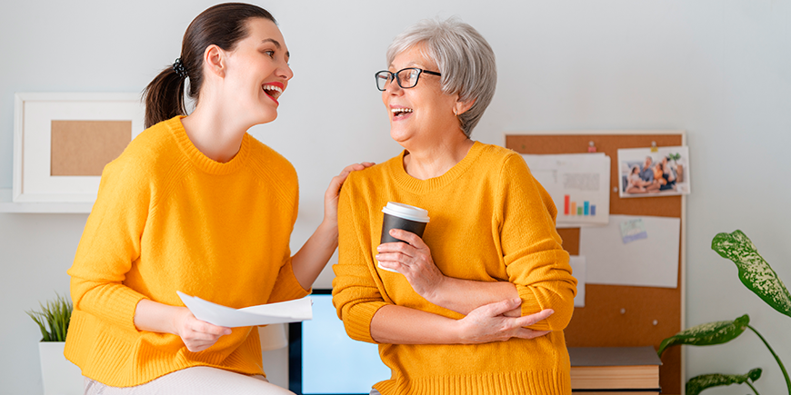 Mujeres riéndose manteniendo una conversación