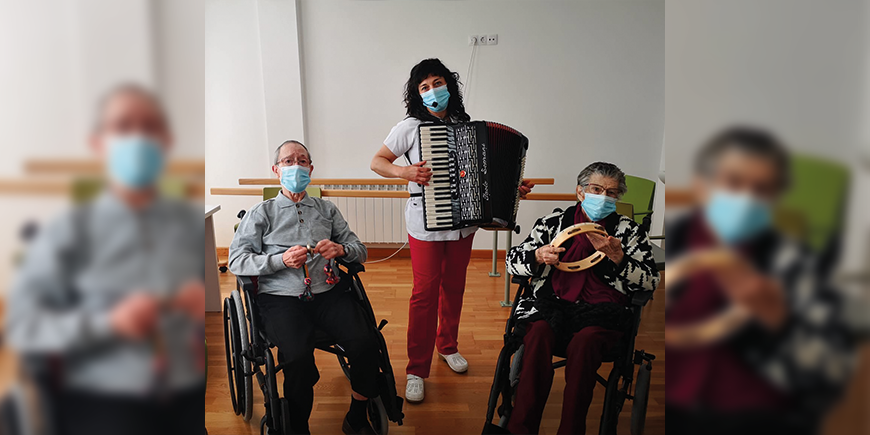 hija tocando el acordeón  con sus padres en un centro de día